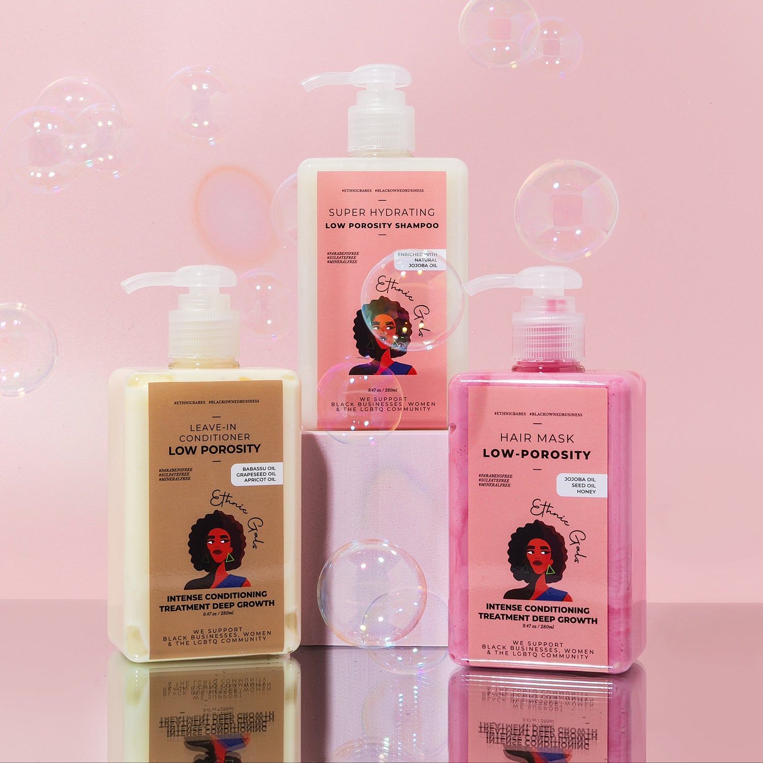 Three hair care products on a pink background with bubbles